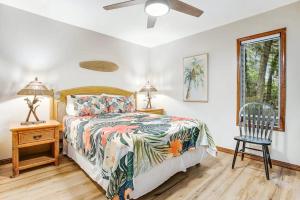 a bedroom with a bed and a table and a chair at Buccaneer Bungalow on Amelia Isle! in Fernandina Beach
