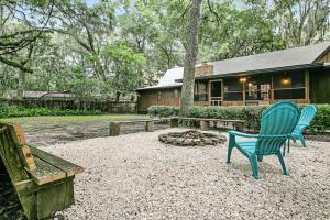 a yard with two chairs and a fire pit at Buccaneer Bungalow on Amelia Isle! in Fernandina Beach
