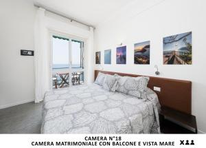 a bedroom with a bed and a large window at Al mare (Guesthouse) in Monterosso al Mare