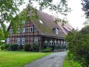 a large brown building with a gambrel roof at Theeshof in Soltau