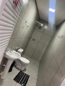 a bathroom with a toilet and a sink and a shower at Área de lazer espaço Reis in Sao Jose do Rio Preto