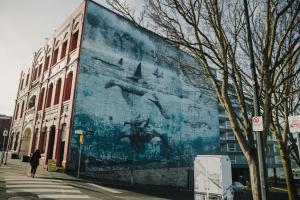 a large mural on the side of a building at The Orca Pad at Waddigton Flats in Victoria