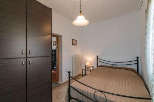 a bedroom with a bed and a dresser at Gavalochori Stone House in Gavalochori +14 photos