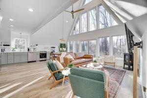a living room with a couch and a table at Modern A-frame in woods with Sauna, HotTub, Privacy in Albrightsville