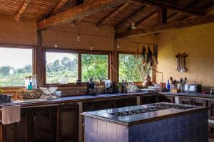 a kitchen with a stove top oven in a room at Finca La Colina in Armenia