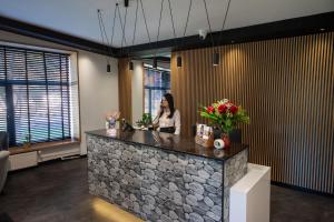 a woman sitting at a counter in a room at WRZOS resort & wellness in Węgierska Górka +259 photos