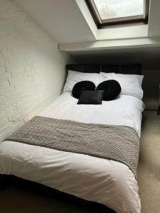 a bed with two pillows on it in a room at Chart Cottage in Stanmore
