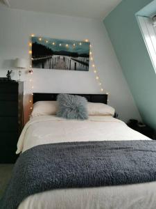 a bedroom with a bed with lights on the wall at The View in Teignmouth