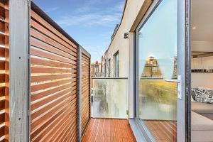 an open balcony with a view of a building at Chic Kensal Green Retreat in London