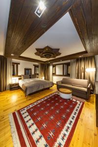 a large bedroom with a bed and a rug at Hotel - Kulla e Zenel Beut in Peje