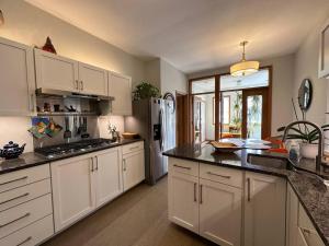 a kitchen with white cabinets and a refrigerator at In Andersonville on Balmoral in Chicago
