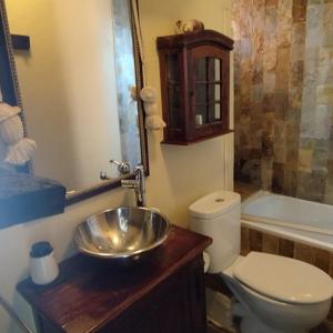 a bathroom with a toilet and a sink at Sierra Nevada Alcazaba in Sierra Nevada