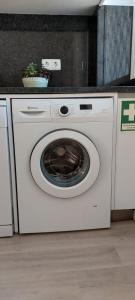 a white washing machine sitting in a kitchen at Sea View Baleal in Peniche