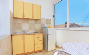 a kitchen with a sink and a refrigerator at Apartments Aurora Adriatica in Brist