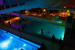 a swimming pool on a cruise ship at night at Gauvik - Lyngdal in Lyngdal