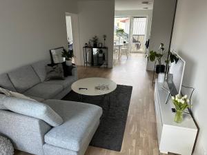 a living room with a couch and a table at Ny lgh i Varberg, 80 kvm, 4 rum in Varberg