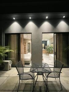 a patio with a glass table and two chairs at FR Hotel in Ibagué