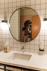 a bathroom with a sink and a mirror at The Grove Motel in Colchester