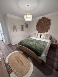 um quarto com uma cama grande e um cobertor verde em Appartement cosy em Meaux