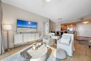 a living room with white furniture and a dining room at Portofino Island P4-605 in Pensacola Beach