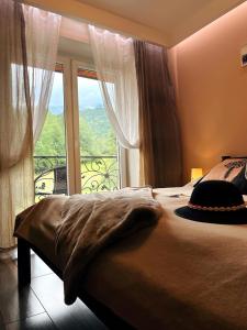 a bedroom with a bed and a large window at HELLO GIEWONT in Zakopane