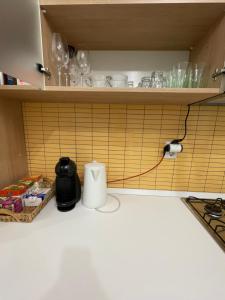 a kitchen with a charger plugged into a wall at Yellow Apartment in Floreşti