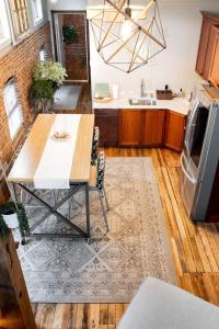 a kitchen with a table and a kitchen with a refrigerator at Sweet Lancaster Apt. A in Lancaster