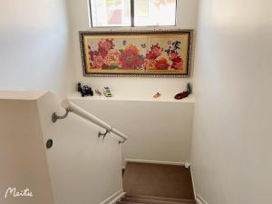 a stairway with a painting on the wall and a stair railing at Maungaraki View in Lower Hutt