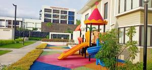 a playground with a slide in front of a building at JHS Condo in Davao City