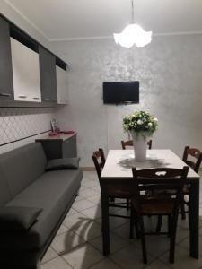 a living room with a couch and a table with flowers at Casa Piero in Lecce
