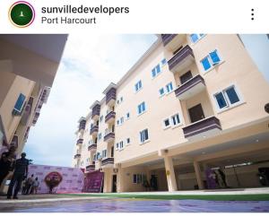 a group of people standing in front of a building at Apartment B16 in Port Harcourt