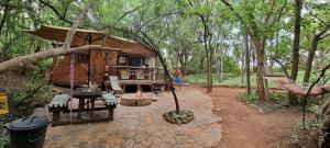 a man standing in front of a tree house at Iris Retreat & Island Day Spa in Hartbeespoort