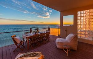 a dining room with a view of the ocean at Blue Dolphin: An Oceanfront Malibu Sanctuary in Malibu