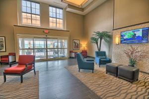 a waiting area in a hospital with chairs and a tv at Comfort Suites Marietta-Parkersburg in Marietta