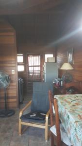 a room with a table and a chair and a table and a refrigerator at Bonibert in Termas de Almirón Inmotur