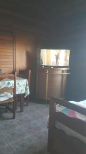 a room with a tv and a table and a table and a table at Bonibert in Termas de Almiron