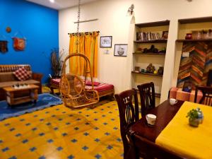 a living room with a table and chairs and a couch at A Chettinad villa in Coimbatore in Coimbatore