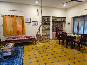 a living room with a couch and a table at A Chettinad villa in Coimbatore in Coimbatore