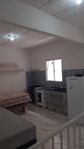 a room with two beds and a window on the wall at Residencial Praia Quente casas in Nova Viçosa