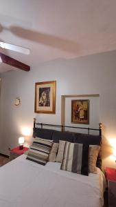 a bedroom with a bed and two pictures on the wall at La Dolce Venezia Guesthouse in Venice