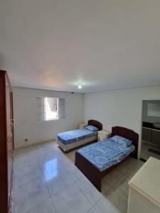 Katil atau katil-katil dalam bilik di Casa grande e aconchegante