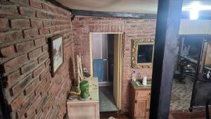 a room with a brick wall and a mirror at Loft casa dos pisos con garage pocitos playa 6 personas in Montevideo +28 photos