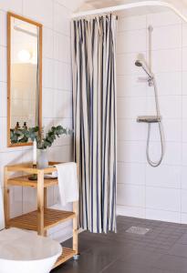 a bathroom with a shower curtain and a sink at Hönö Sjöbodar in Hönö