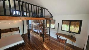 a bedroom with a bunk bed and a spiral staircase at Binga Beach Palawan Glamping in San Miguel