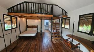 a room with a bunk bed and a staircase at Binga Beach Resort in San Miguel