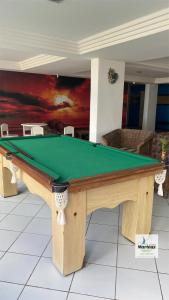 a pool table in a living room at Apart Hotel Marinas Tamandaré in Tamandaré