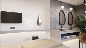 Megálon ChoríonにあるUtopia Luxury Resortのバスルーム(洗面台2台、壁掛けテレビ付)