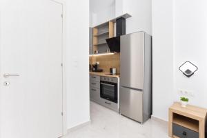 a kitchen with a refrigerator and a stove at New Luxury Apartment in Downtown in Thessaloniki