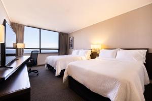 a hotel room with two beds and a desk at Holiday Inn Express - Iquique, an IHG Hotel in Iquique