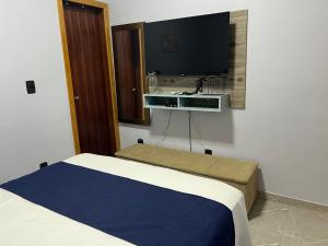 a bedroom with a bed and a sink on the wall at Kitnets Cidade de Goiás-Go 02 in Goiás